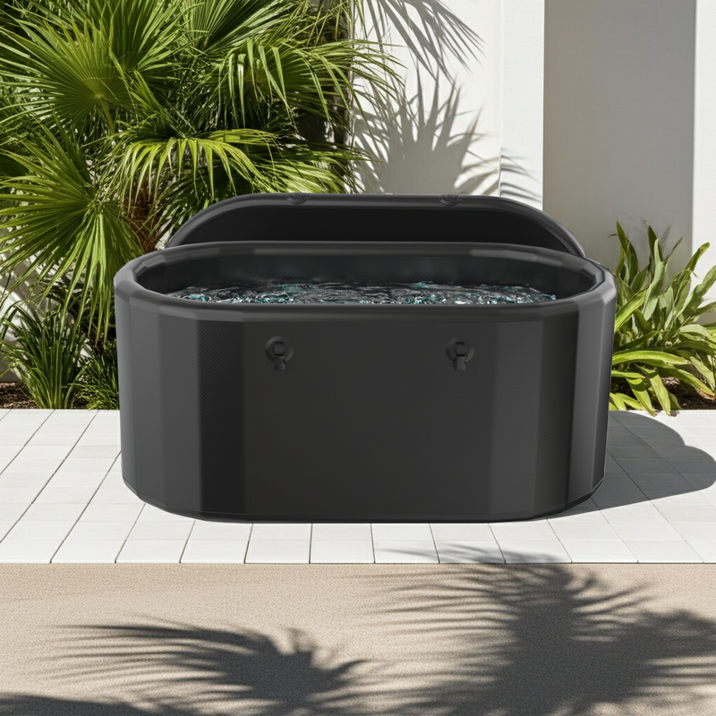 Arctic Ritual Lite+ portable cold plunge tub in matte black finish filled with water in a tropical outdoor setting