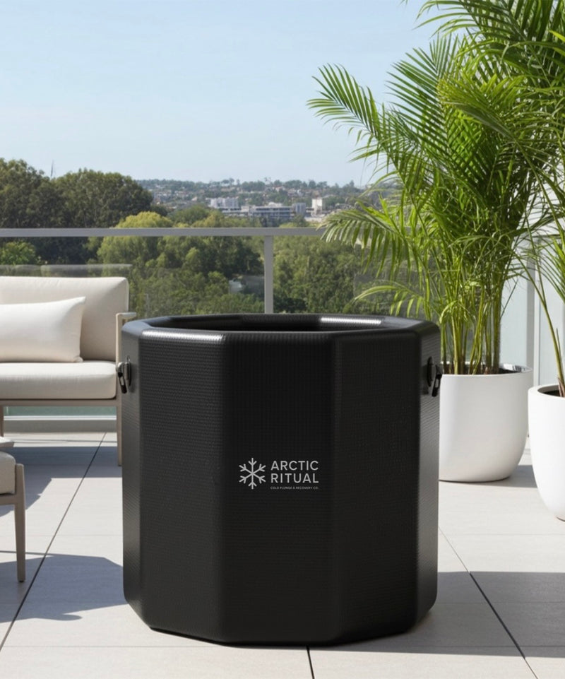Arctic Ritual black cold plunge tub on a modern outdoor balcony, premium ice bath for home recovery and cold therapy