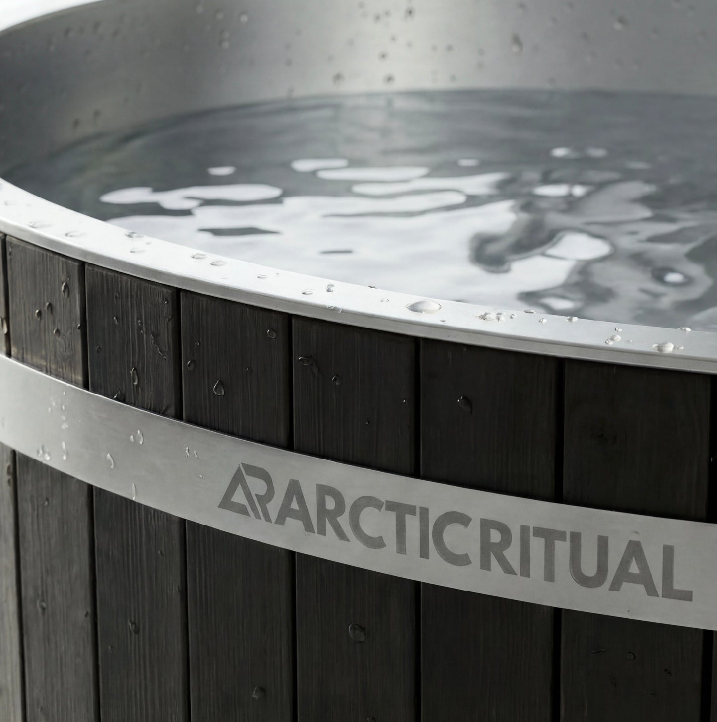 Close-up of Arctic Ritual cedar cold plunge tub showing stainless steel rim, timber exterior panels and water surface detail, premium ice bath for home recovery and cold exposure.