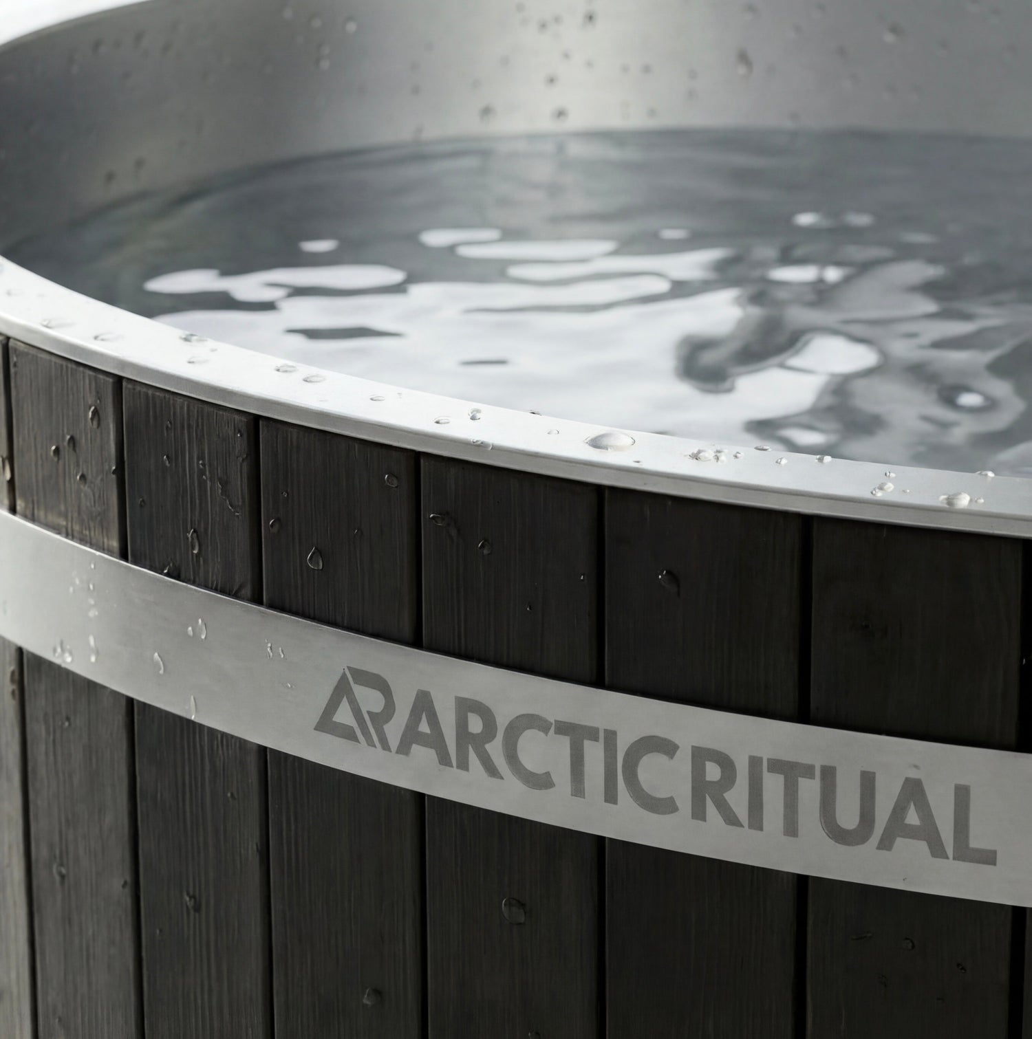 Close-up of Arctic Ritual cedar cold plunge tub showing stainless steel rim, timber exterior panels and water surface detail, premium ice bath for home recovery and cold exposure.