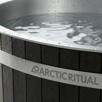 Close-up of Arctic Ritual cedar cold plunge tub showing stainless steel rim, timber exterior panels and water surface detail, premium ice bath for home recovery and cold exposure.