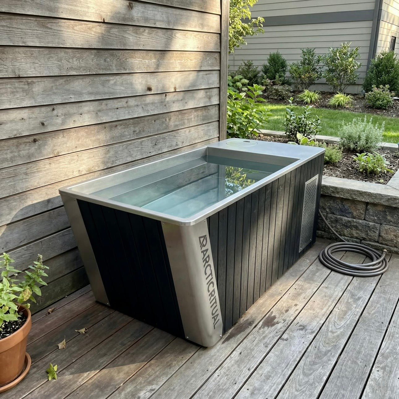Arctic Ritual Platinum All-in-One cold plunge tub installed on backyard deck for home ice bath and cold therapy