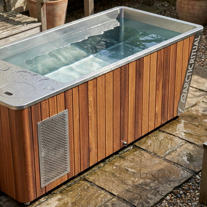Arctic Ritual Platinum All-in-One cold plunge tub in cedar finish installed outdoors for home ice bath and recovery